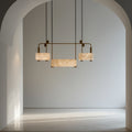 Three ivory-toned veined shades on a brass-toned linear frame with a lower central shade